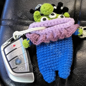 adorable handmade crochet alien key pouch is crafted with soft, durable cotton, perfect for keeping your car keys and door keys safe and organized. featuring a cute alien design with vibrant colors and playful details, this key bag adds a fun, whimsical touch to your daily accessories. the compact, lightweight design fits easily in your pocket or bag, while the secure drawstring closure keeps keys from falling out. it’s a unique handmade gift for alien lovers, car owners, or anyone who loves cute, practical accessories—blending functionality with charming style.put it in the bag, no longer worry about the car keys scratching the phone.
