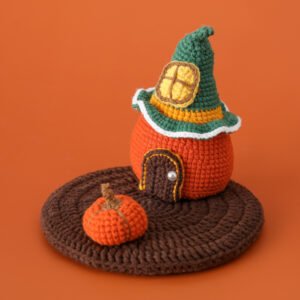 hand knitted pumpkin house phone stand, soft cotton yarn, unique whimsical charm, safe & functional decor, meaningful cozy keepsake.