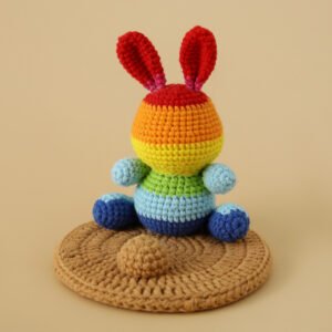 hand knitted rainbow rabbit phone stand, soft cotton yarn, unique playful charm, safe & functional decor, cheerful keepsake
