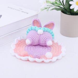 hand knitted bunny butt phone stand, soft cotton yarn, unique cute charm, safe & functional decor, meaningful playful keepsake.