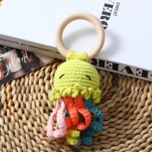 hand crochet green octopus teething rattle, soft cotton yarn with wooden ring, safe sensory toy for babies, meaningful newborn keepsake